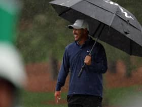 Brooks Koepka shelters under a brolley on a wet day at Augusta National Golf Club. Picture: Patrick Smith/Getty Images.