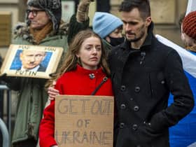 A couple of demonstrators holding a sign which reads "Get out of Ukraine". (Picture credit: Lisa Ferguson)