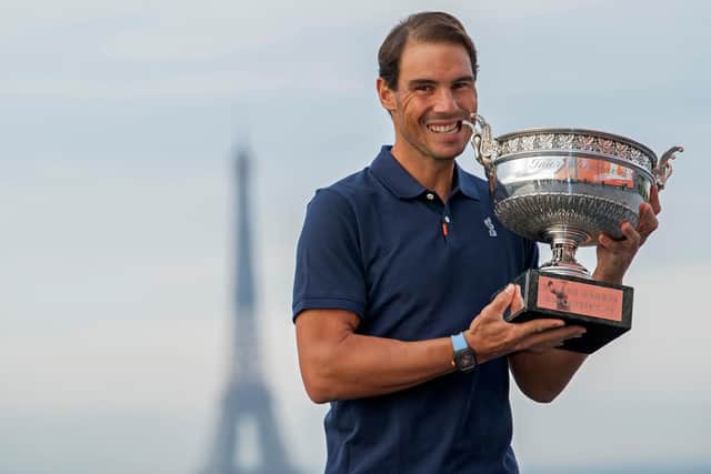 Rafael Nadal on top of Paris with the French Open trophy, the victory which draws him level with Roger Federer at the Slam summit