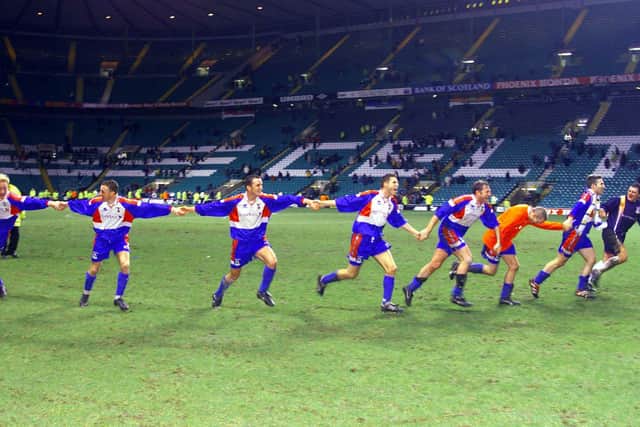 The Inverness players celebrate their victory at Celtic Park.