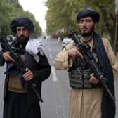 Taliban fighters stand guard near the former presidential palace in Kabul (Picture: Wakil Kohsar/AFP via Getty Images)