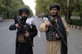 Taliban fighters stand guard near the former presidential palace in Kabul (Picture: Wakil Kohsar/AFP via Getty Images)