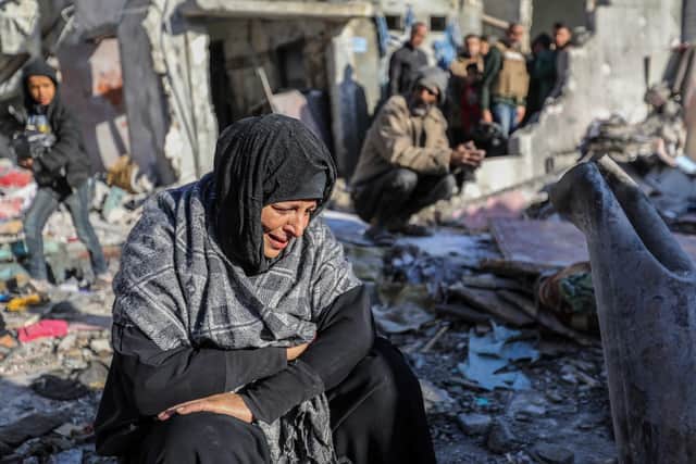 A woman sits amid the rubble of homes hit by Israeli air strikes in Rafah, Gaza, earlier this month (Picture: Ahmad Hasaballah/Getty Images)