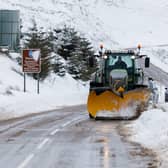 A snow plough clears the A939 after heavy snowfall in the Scottish Highlands.