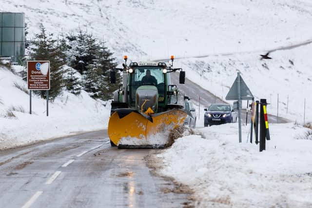 A snow plough clears the A939 after heavy snowfall in the Scottish Highlands.