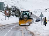 A snow plough clears the A939 after heavy snowfall in the Scottish Highlands.