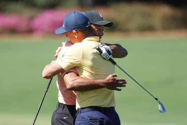 Tiger Woods embraces Billy Horschel on the practice area at Augusta National Golf Club. Picture: Gregory Shamus/Getty Images.