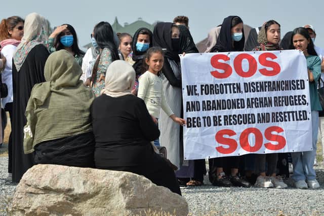 Afghan refugees beg for help at a rally in front of the US Embassy in Bishkek, Kyrgyzstan (Picture: Vyacheslav Oseledko/AFP via Getty Images)