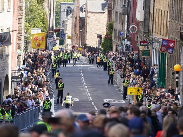 Police officers on the Royal Mile in Edinburgh ahead of the procession of Queen Elizabeth's coffin from the Palace of Holyroodhouse to St Giles' Cathedral, Edinburgh, following her death on Thursday. Picture date: Monday September 12, 2022.