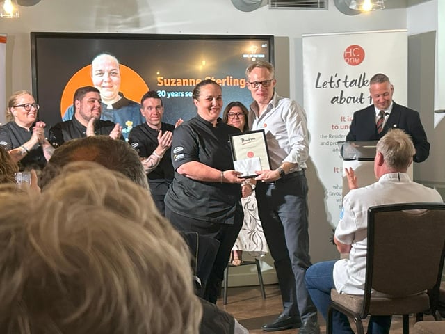 Suzanne Stirling, Group Development Chef at HC-One being presented with her 20 year long service award by James Tugendhat, Chief Executive Officer at HC-One at the HC-One Chef of the Year Competition 2025