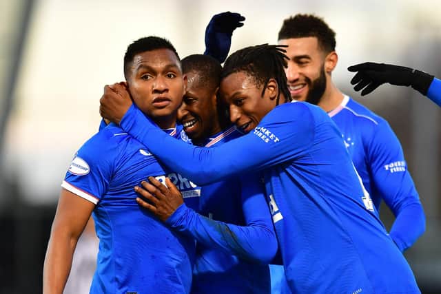 Alfredo Morelos celebrates with Glen Kamara and Joe Aribo after scoring Rangers' second goal against St Mirren on Wednesday as they racked up a 13th consecutive win in the Scottish Premiership. (Photo by Mark Runnacles/Getty Images)