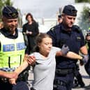 Climate activist Greta Thunberg is carried away by police officers after taking part in a protest in Malmo, Sweden, on July 24 (Picture: Andreas Hillergren/TT News Agency/AFP via Getty Images)