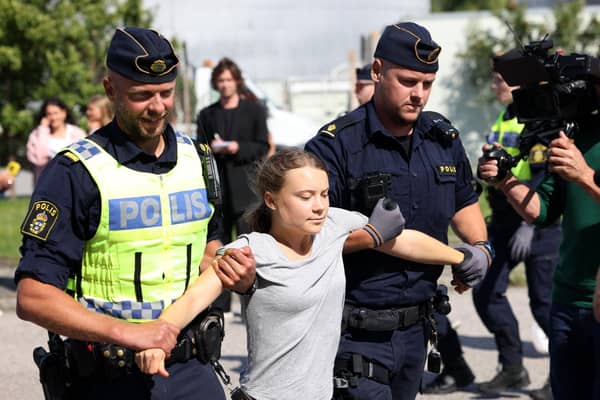 Climate activist Greta Thunberg is carried away by police officers after taking part in a protest in Malmo, Sweden, on July 24 (Picture: Andreas Hillergren/TT News Agency/AFP via Getty Images)