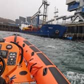 The Kyle Lifeboat crew were called out to tow a boat that became wedged between a pier and a cargo vessel under the Skye Bridge.