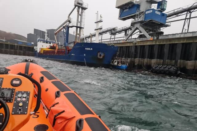 The Kyle Lifeboat crew were called out to tow a boat that became wedged between a pier and a cargo vessel under the Skye Bridge.