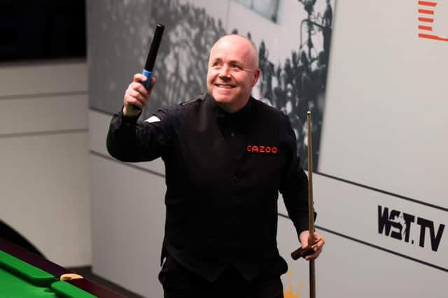John Higgins of Scotland celebrates victory following their round two match against Kyren Wilson of England on Day Nine of the Cazoo World Snooker Championship 2023.