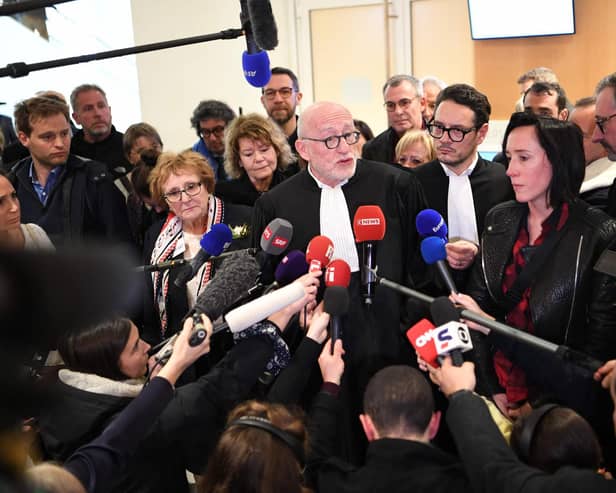 French lawyer Alain Jakubowicz (C) talks to the press next to Ophelie Toulliou, sister of a victim of the crash (2R) at the Paris courthouse on April 17, 2023 after the trial of Air France and plane manufacturer Airbus for the crash of the Rio-Paris Air France flight A330 on June 1, 2009 which killed 228 people.  Photo by Bertrand Guay