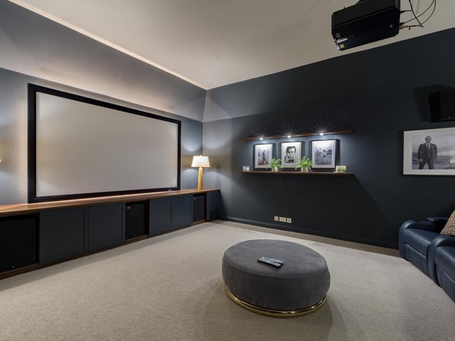 The extension to the side, which houses a spectacular kitchen, games room and home cinema, is new.