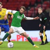 Jamie McCart and Hibs striker Christian Doidge battle for possession during St Johnstone's win at Hampden earlier in the season. Picture: SNS