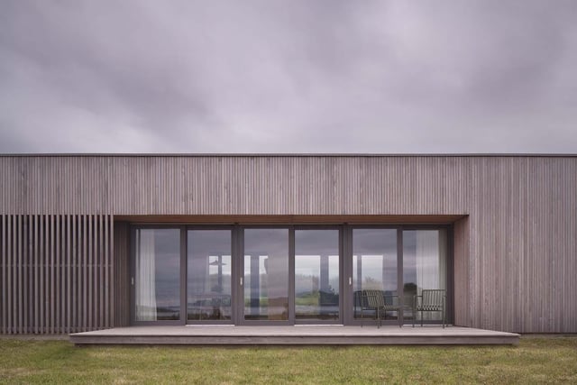 Half of Eleven was designed by Dualchas Architects as a self-build house, which the owners have built themselves on a modest budget as they work to regenerate their long-held but neglected croft in the coastal township of Breakish. The new house appears as a simple and unobtrusive addition to the landscape, with large windows in the main living space providing beautiful views, and timber cladding used to allow the building to blend naturally with its surroundings. The extensive use of timber continues inside, bringing texture and warmth to the home’s bright and airy spaces. This project demonstrates that architecture does not need large footprints and budgets to create rural buildings of great character.