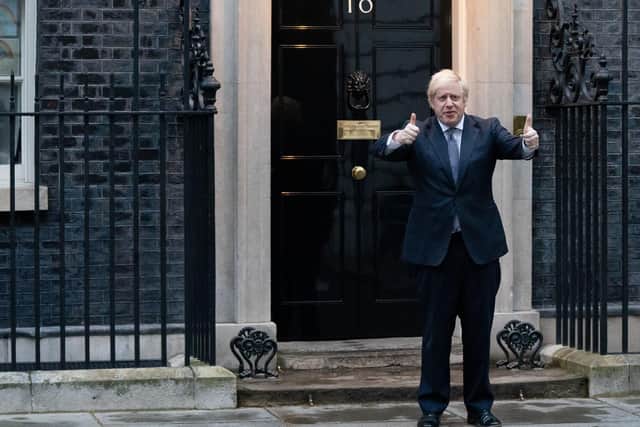 Prime Minister Boris Johnson stands outside 10 Downing Street in London as he joins in the applause to salute local heroes during Thursday's nationwide Clap for Carers