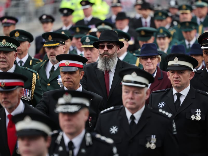 London Fire Brigade and London Ambulance Service members parade near the Cenotaph in London
