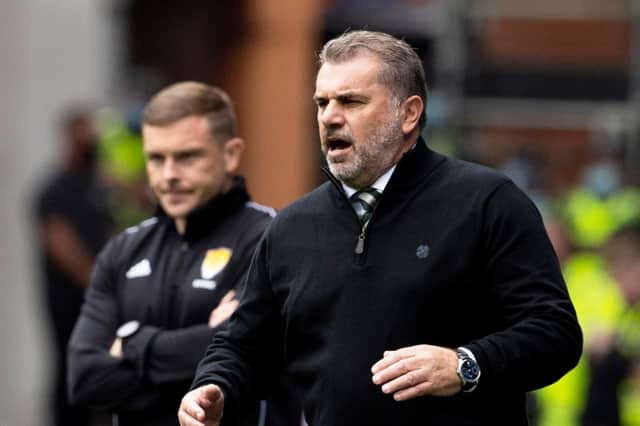 Celtic manager Ange Postecoglou watches on from the Ibrox touchlines against Rangers.