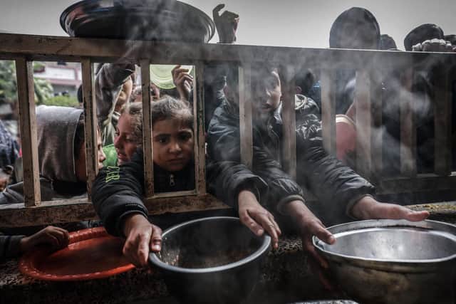 Displaced Palestinian children gather to receive food at a government school in Rafah in the southern Gaza Strip (Picture: Mohammed Abed/AFP via Getty Images)