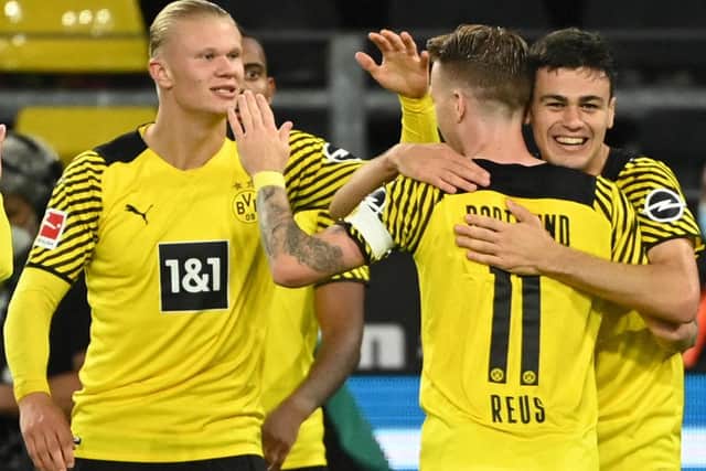 Dortmund's US midfielder Giovanni Reyna celebrates with Marco Reus and Erling Braut Haaland (Photo by INA FASSBENDER/AFP via Getty Images)