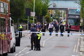 Police officers inside the cordon in Hainault, north east London, where a 36-year-old man wielding a sword was arrested after an attack on members of the public and two police officers. Photo: Jordan Pettitt/PA Wire
