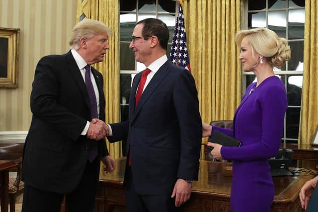Steven Mnuchin and his wife, Louise Linton, with Donald Trump in the Oval Office of the White House. Picture: Alex Wong/Getty