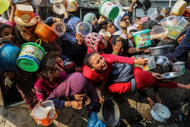 Desperate people queue for food in Rafah, Gaza (Picture: Ahmad Hasaballah/Getty Images)
