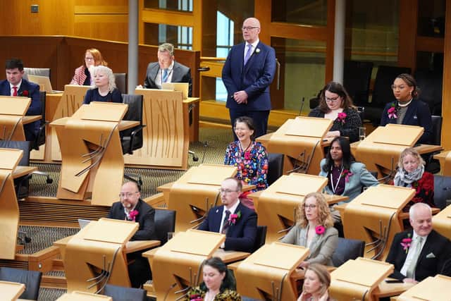 First Minister John Swinney stands waiting to be sworn in during the first sitting day of the new Scottish Parliament yesterday (Picture: Jane Barlow/PA Wire)
