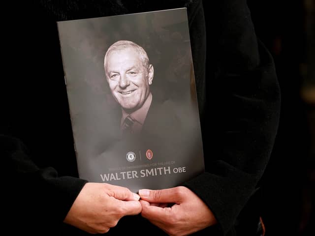 A person holds the order of service during Walter Smith's memorial service at Glasgow Cathedral.