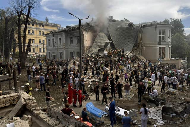 Rescuers clear the rubble of the destroyed Ohmatdyt Children's Hospital following a missile attack in Kyiv
