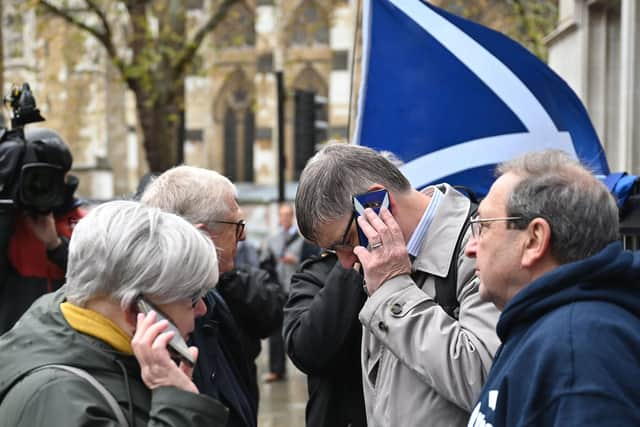 Scottish independence supporters outside the Supreme Court in London listen to the referendum ruling being delivered (Picture: Justin Tallis/AFP via Getty Images)