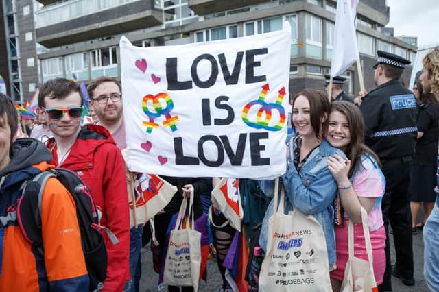 Pride marchers, pictured in Glasgow in 2017, make a point about love (Picture: Robert Perry/Getty Images)