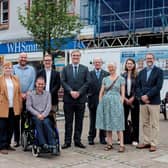 Community wealth minister Tom Arthur, centre, with members of Midsteeple Quarter, other project funders and contractors in front of the construction site on Dumfries High Street.