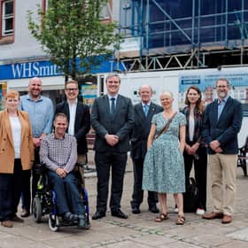Community wealth minister Tom Arthur, centre, with members of Midsteeple Quarter, other project funders and contractors in front of the construction site on Dumfries High Street.