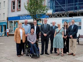 Community wealth minister Tom Arthur, centre, with members of Midsteeple Quarter, other project funders and contractors in front of the construction site on Dumfries High Street.