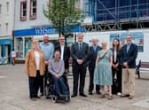 Community wealth minister Tom Arthur, centre, with members of Midsteeple Quarter, other project funders and contractors in front of the construction site on Dumfries High Street.