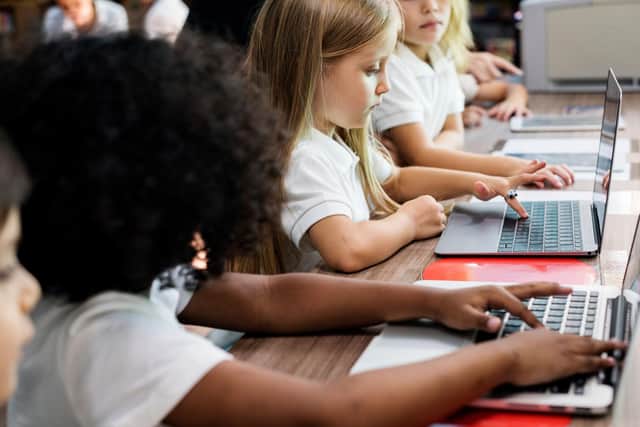 Children using laptops at school
