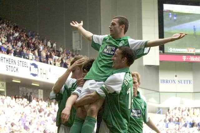 Ivan Sproule rejoices with his Hibs team-mates after netting his third goal of the game against Rangers.
