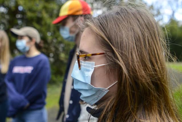 Students wearing face masks on a campus in York.