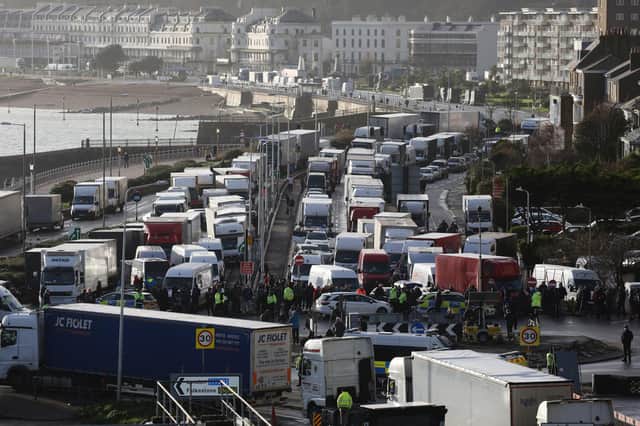 Police officers patrol in front of queues of vans and lorries at the Port of Dover after the French border is closed