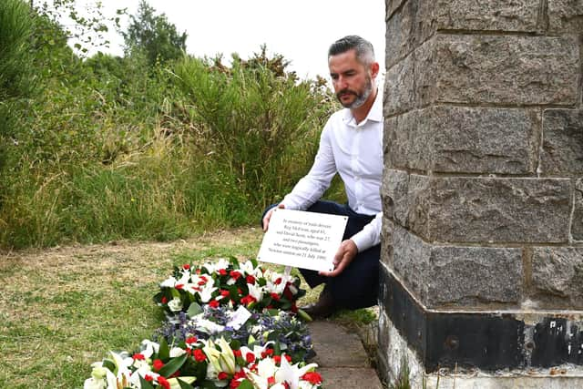 Stuart Scott with the new plaque and wreaths for his brother David and the three others who died in the crash. Picture: John Devlin