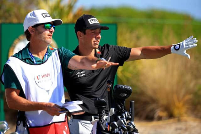 Viktor Hovland talks through a shot with his caddie during the first round of the Hero World Challenge at Albany Golf Course in the Bahamas. Picture: Mike Ehrmann/Getty Images.