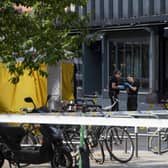 Police investigators are seen working at the crime scene on June 25, 2022, in the aftermath of a shooting outside pubs and nightclubs in central Oslo killing two people. via Getty Images)