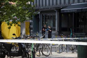 Police investigators are seen working at the crime scene on June 25, 2022, in the aftermath of a shooting outside pubs and nightclubs in central Oslo killing two people. via Getty Images)