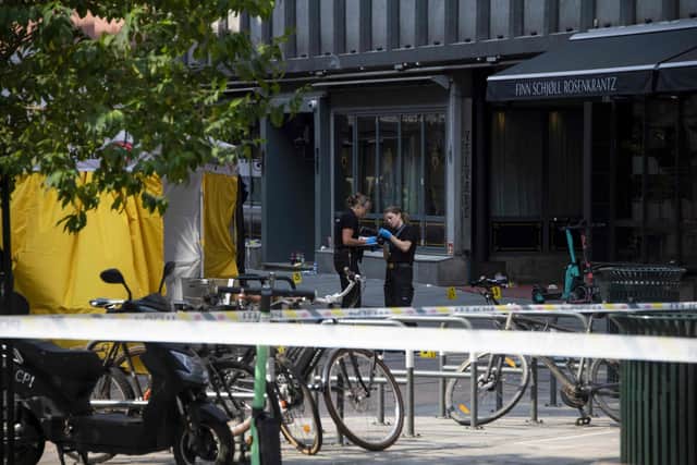Police investigators are seen working at the crime scene on June 25, 2022, in the aftermath of a shooting outside pubs and nightclubs in central Oslo killing two people. via Getty Images)